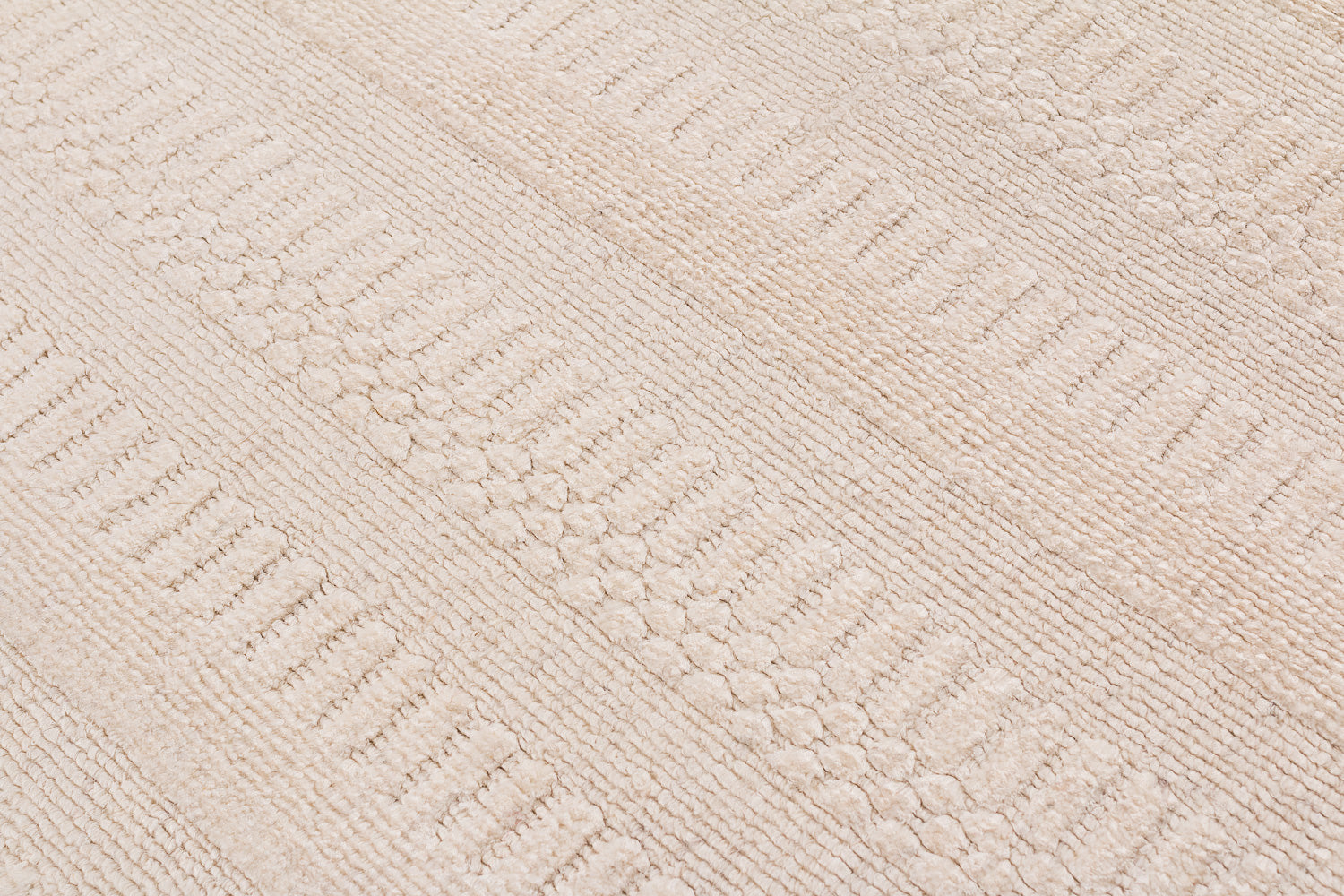 Close-up of a textured beige carpet with a diamond pattern