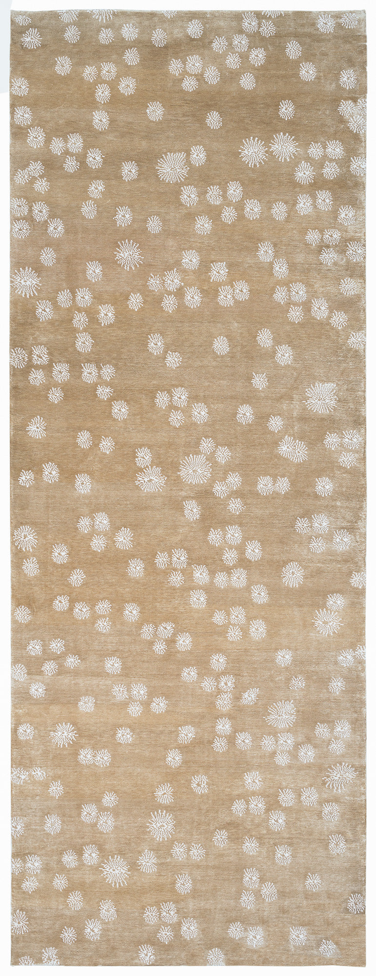 Beige rug with white floral pattern