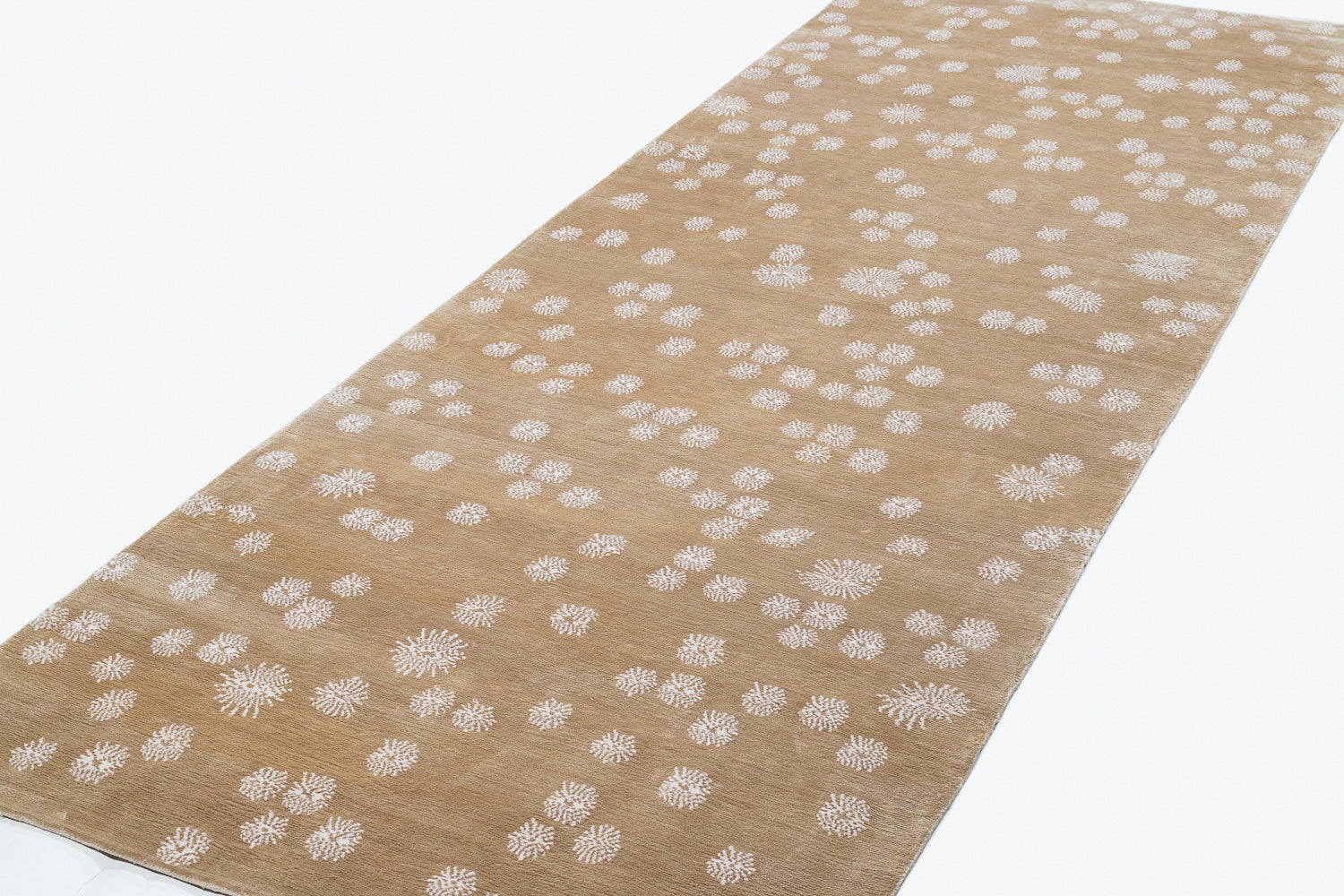 Beige runner with white floral pattern on a white background