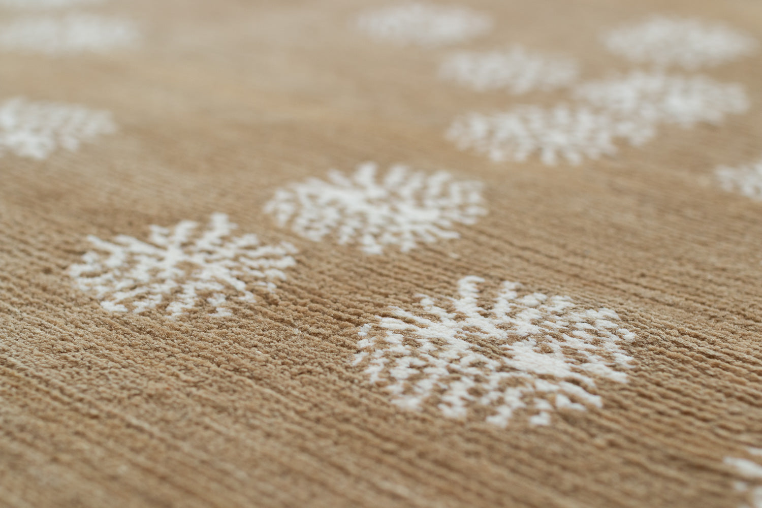 Close-up of white floral patterns on a textured brown carpet