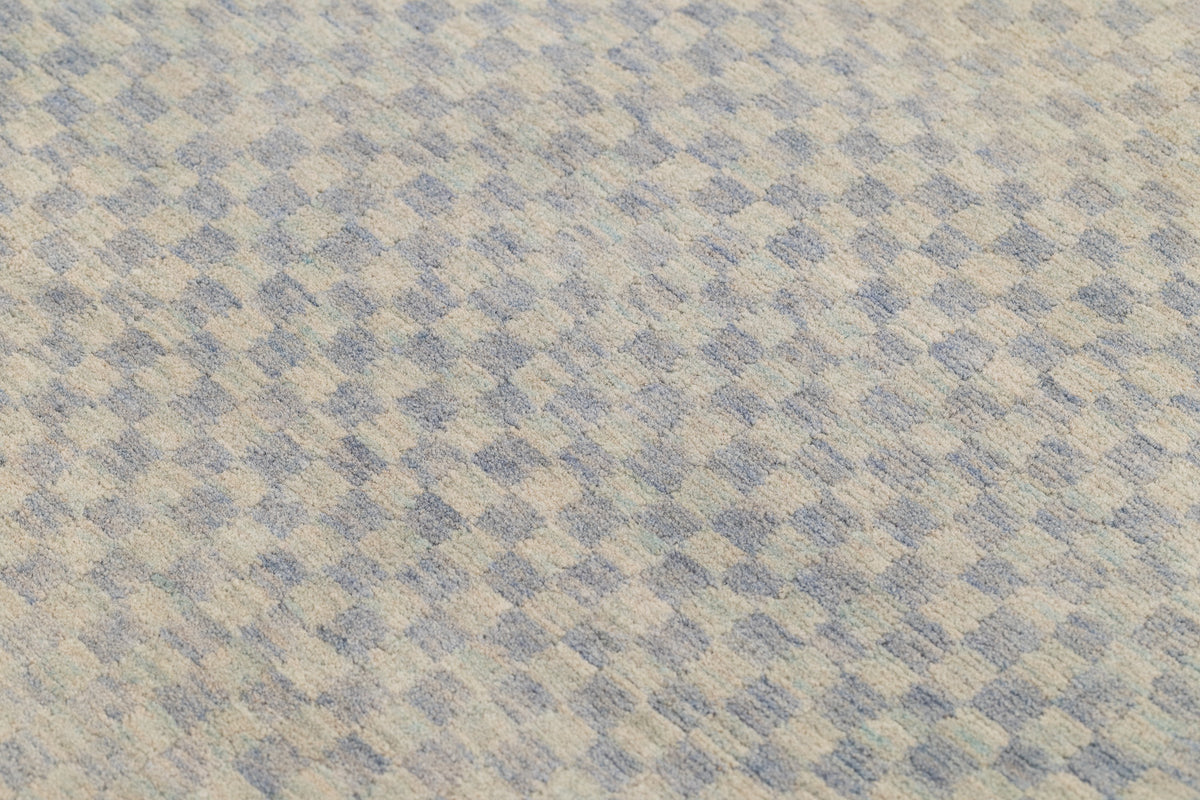close up of light indigo checkerboard rug